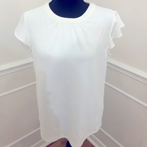 Cute white top with flutter sleeves.